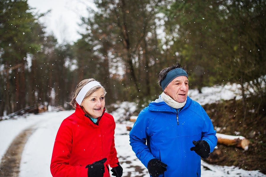 Senior Couple jogging in the snow