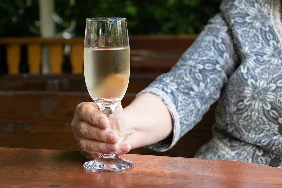 Woman holding a glass of white wine