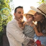 happy family blowing bubbles