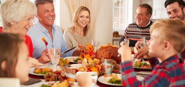 extended family eating thanksgiving dinner