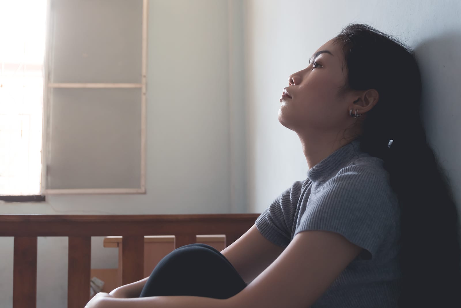 depression asian woman is sad and stress in bedroom, close up at face