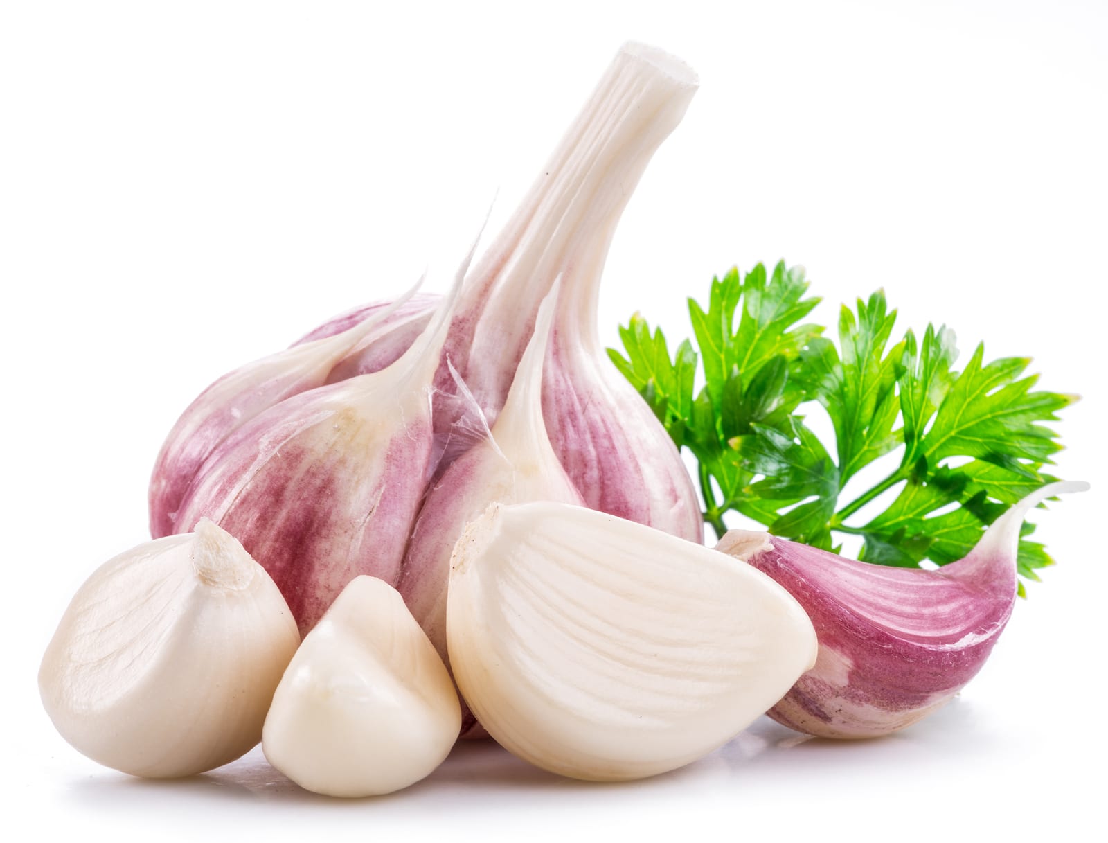 Garlic bulb, garlic cloves and parsley isolated on white background.