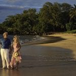 senior couple walking on a maui beach at sunset ** Note: Slight blurriness, best at smaller sizes