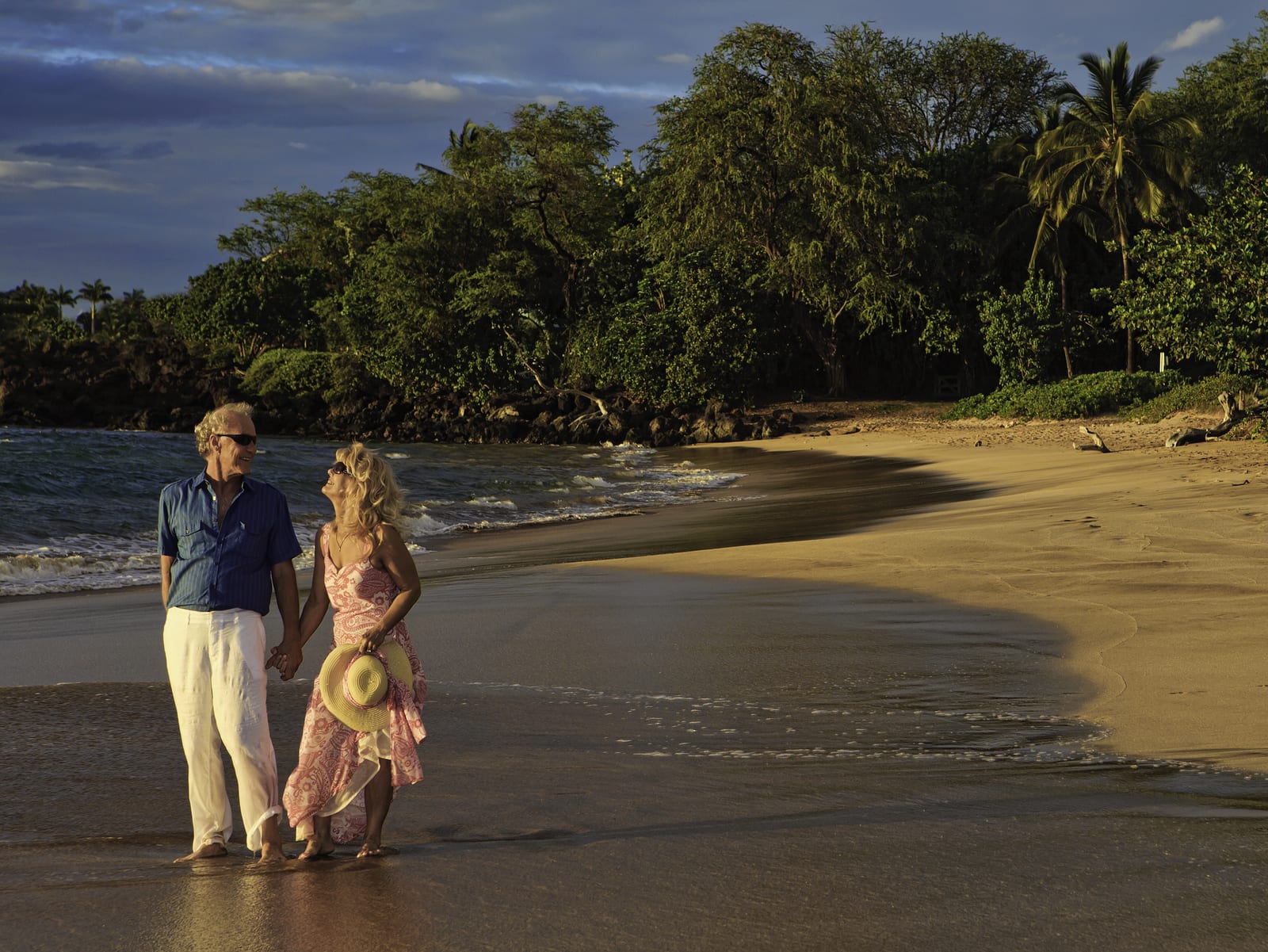 senior couple walking on a maui beach at sunset ** Note: Slight blurriness, best at smaller sizes