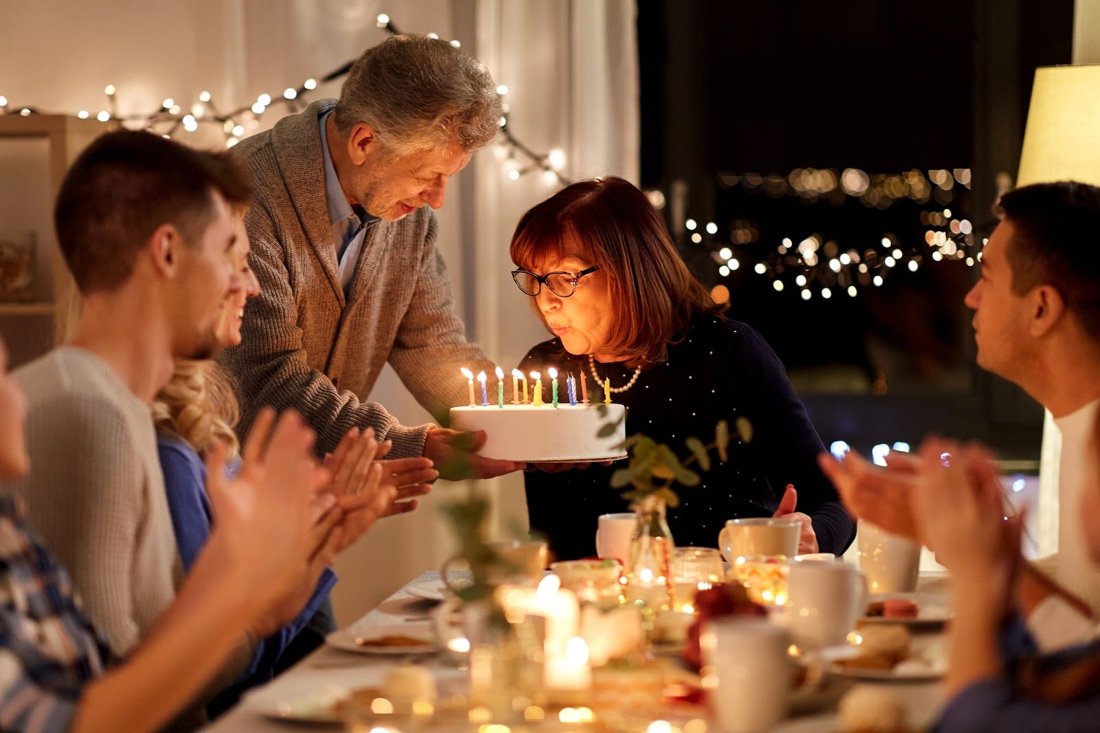 family celebrating a woman's birthday