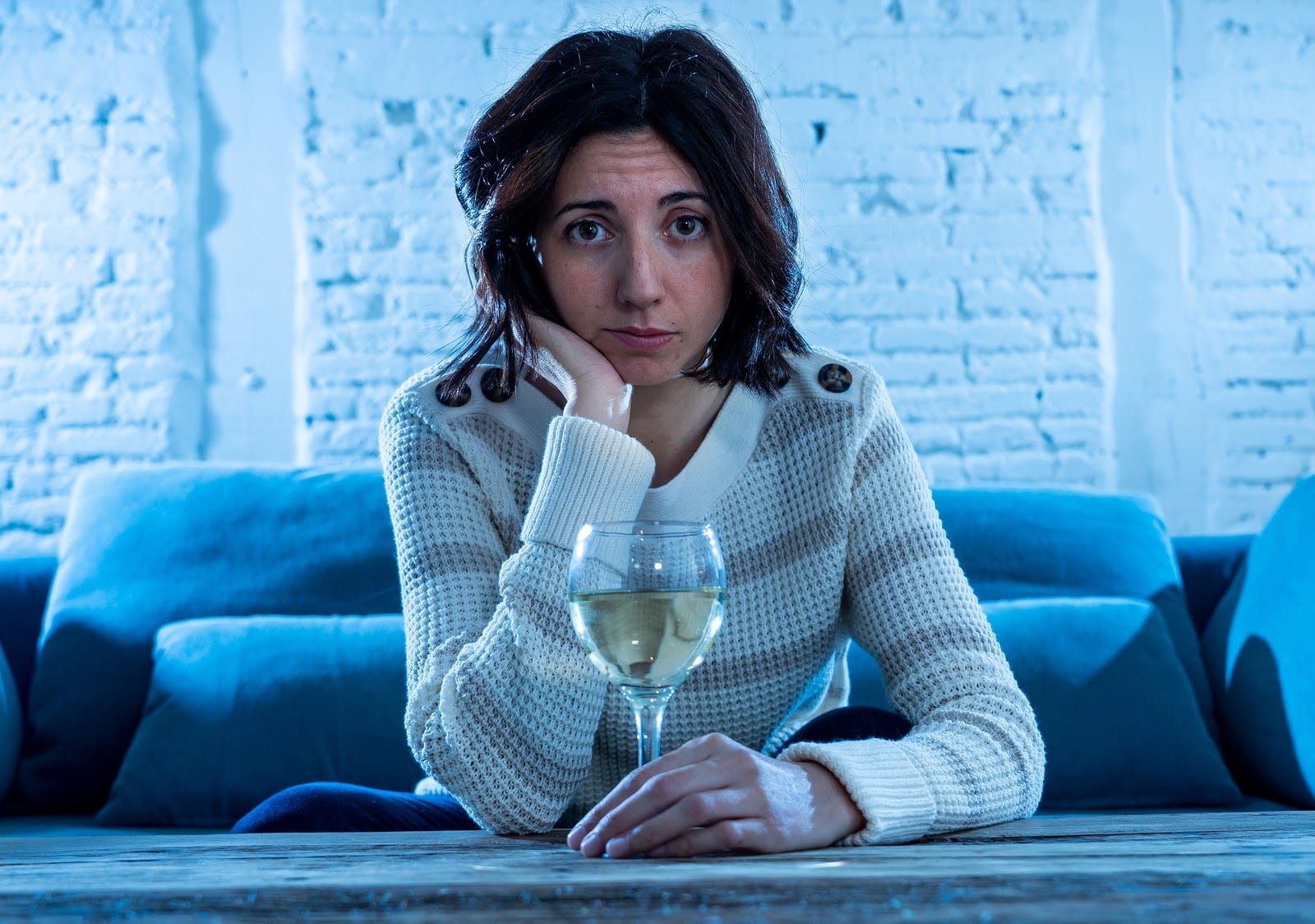 Woman drinking wine on a couch