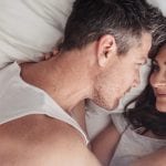 heterosexual couple in laying in bed